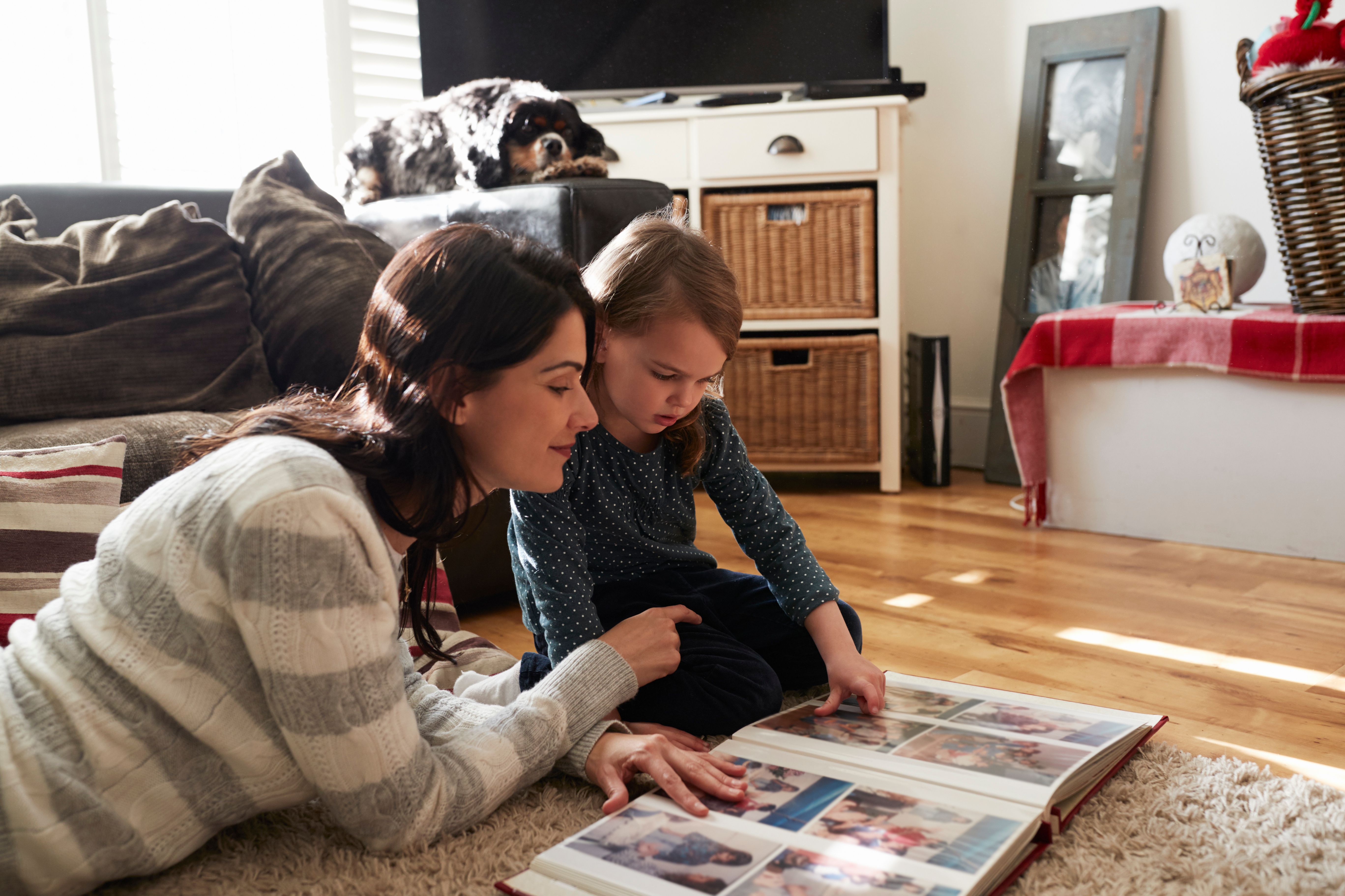 Mom and child look at photo album