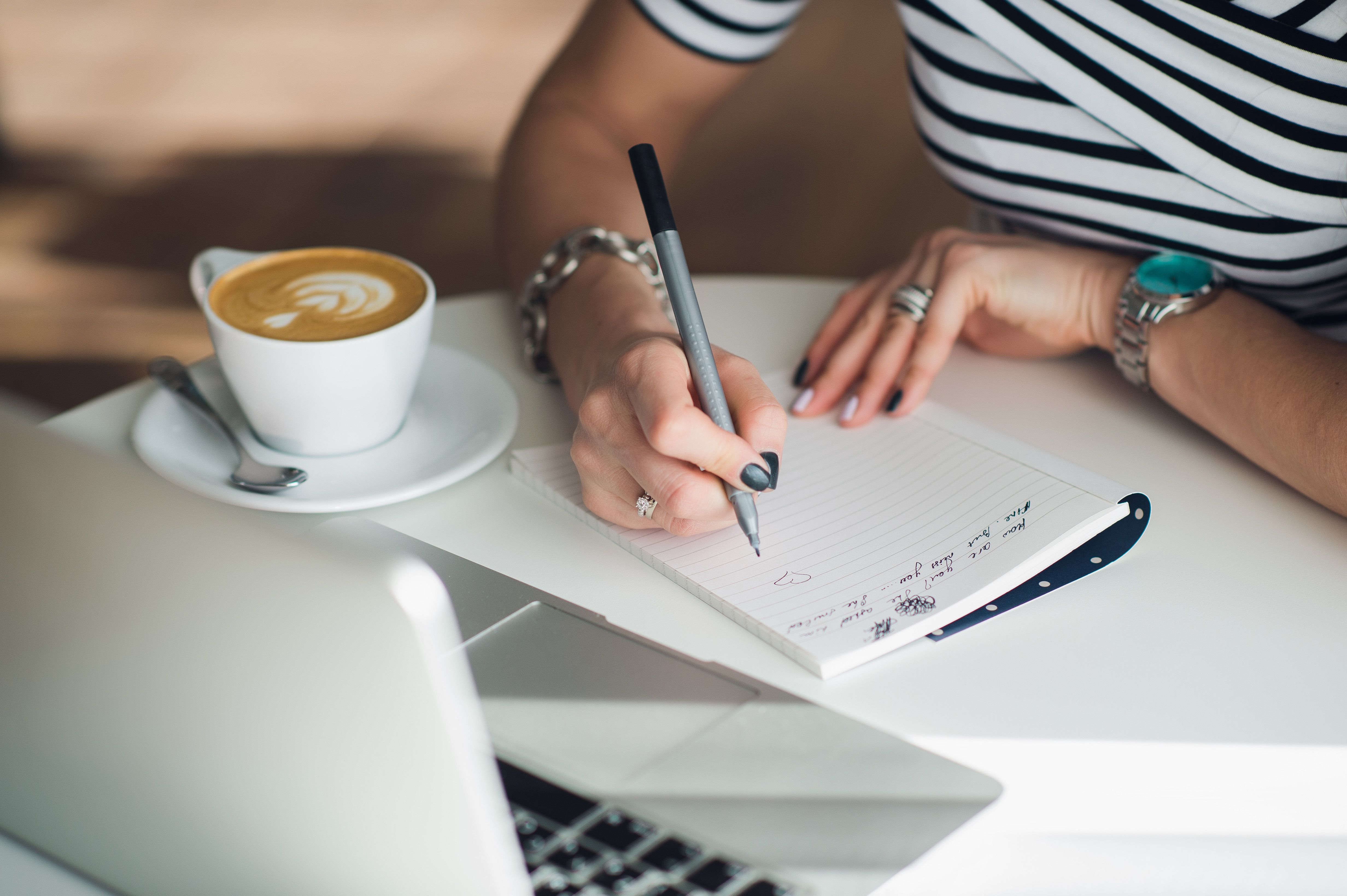 Woman writing a letter on table