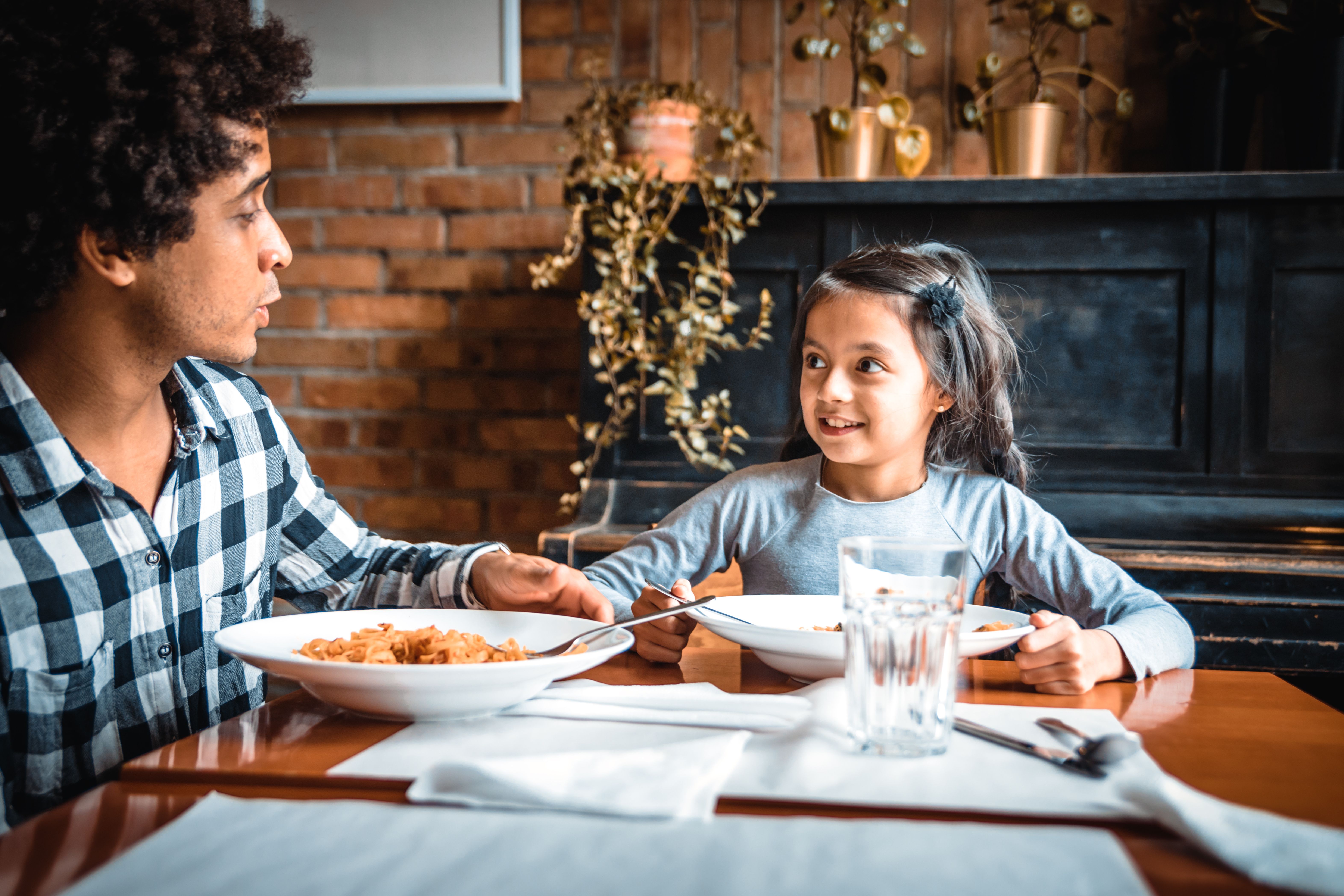 dad and daughter enjoying meal together