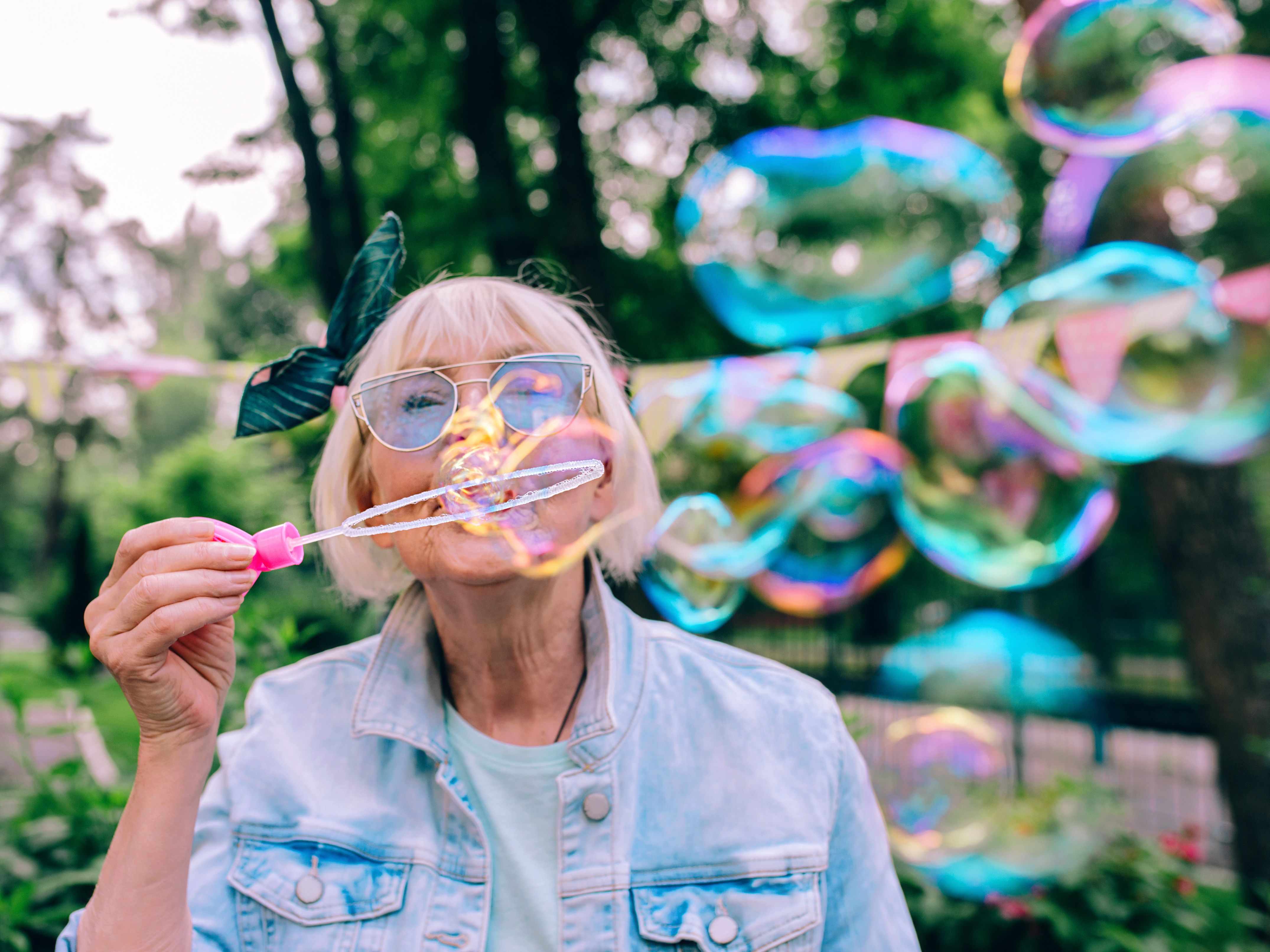 Elderly woman blowing bubbles