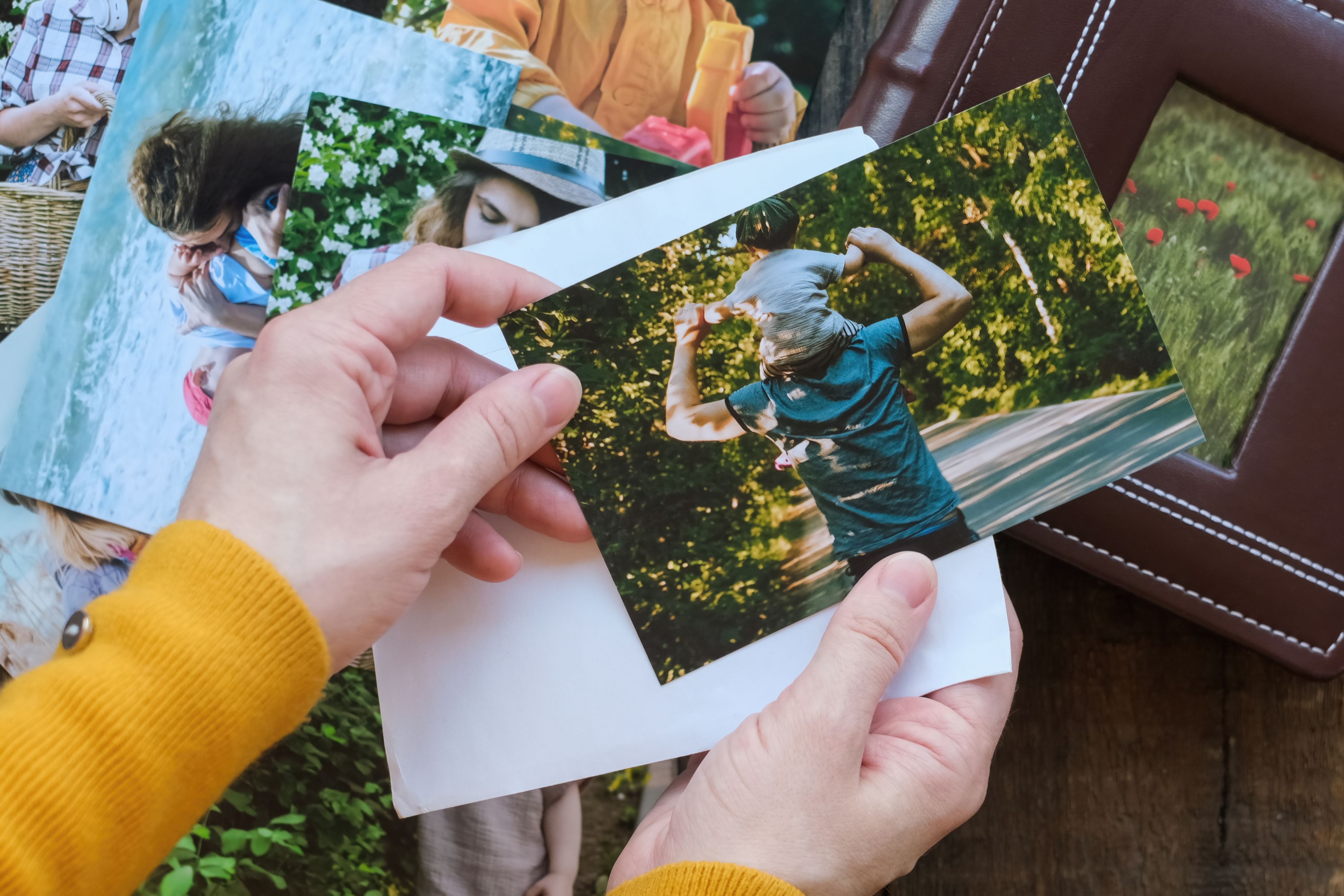 Hands holding printed photos