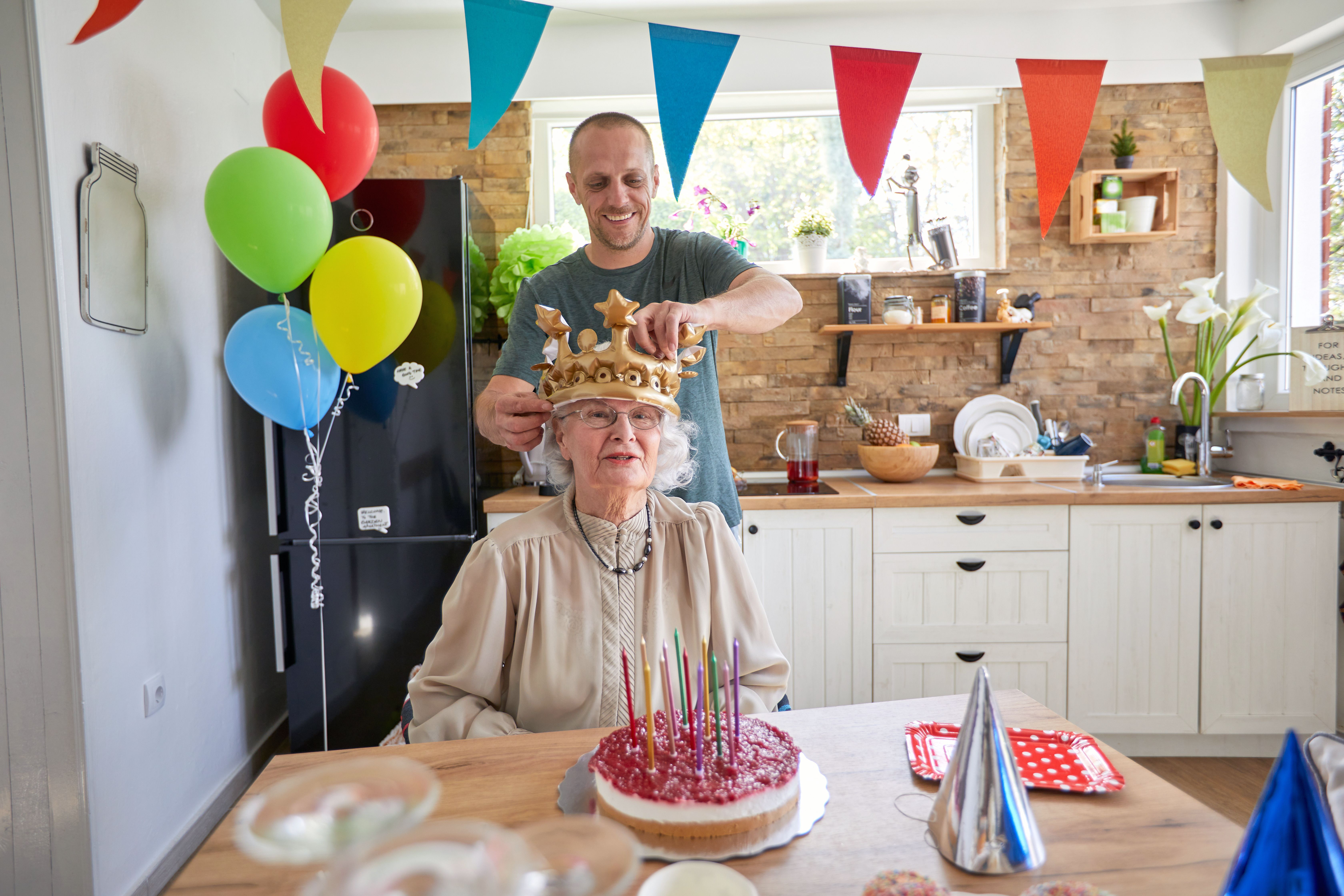 Grandma getting fitted with fun birthday crown