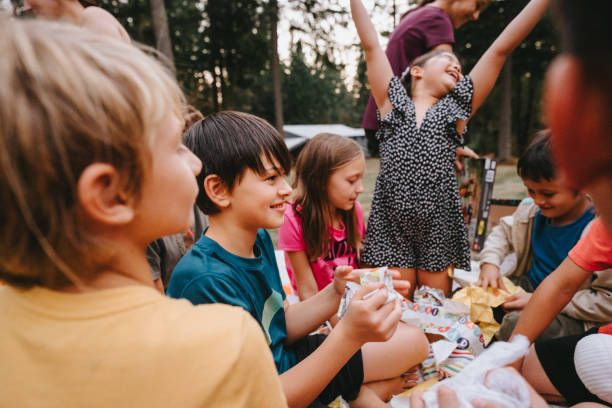young friends around birthday table outside summer