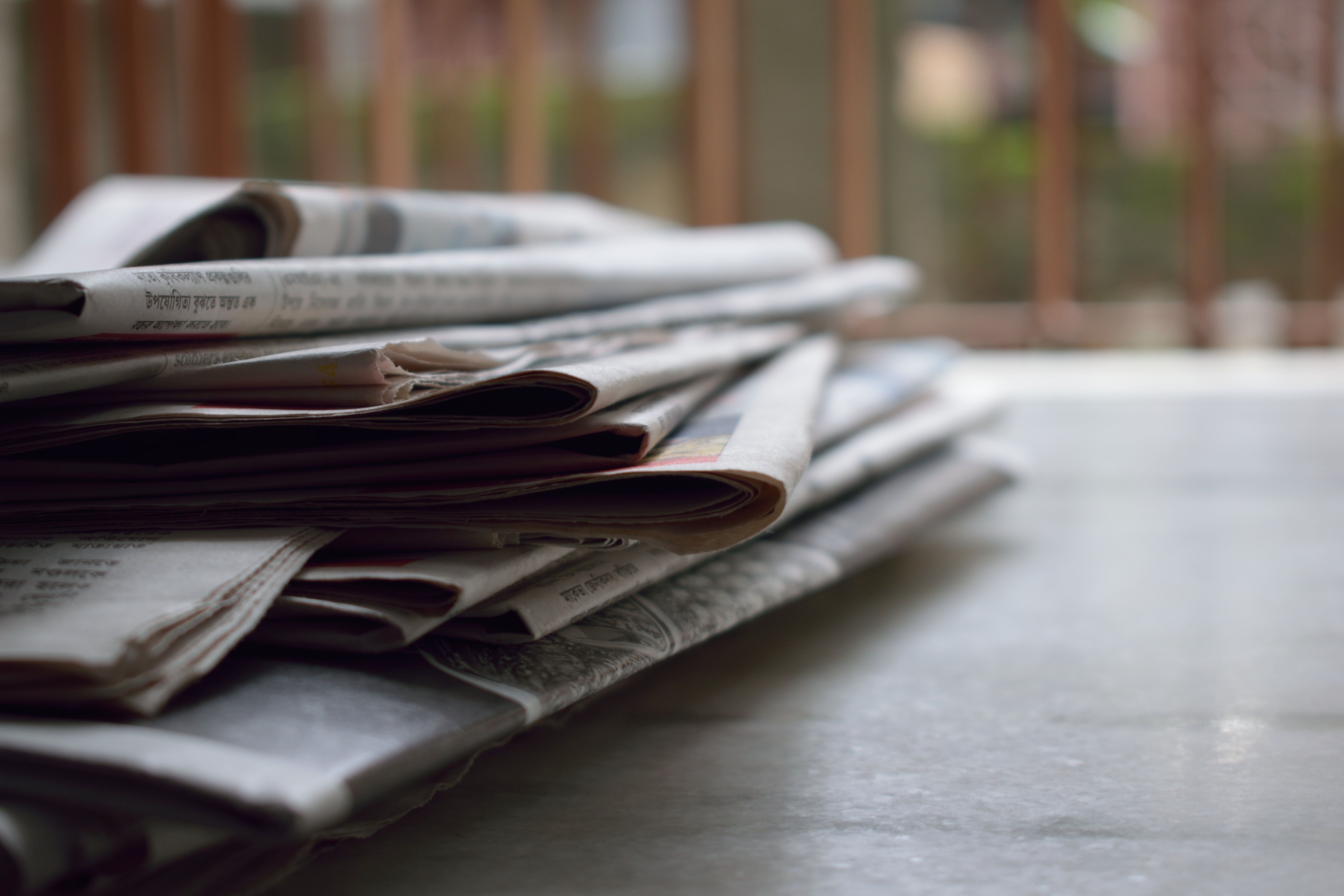 Stacked newspapers on table