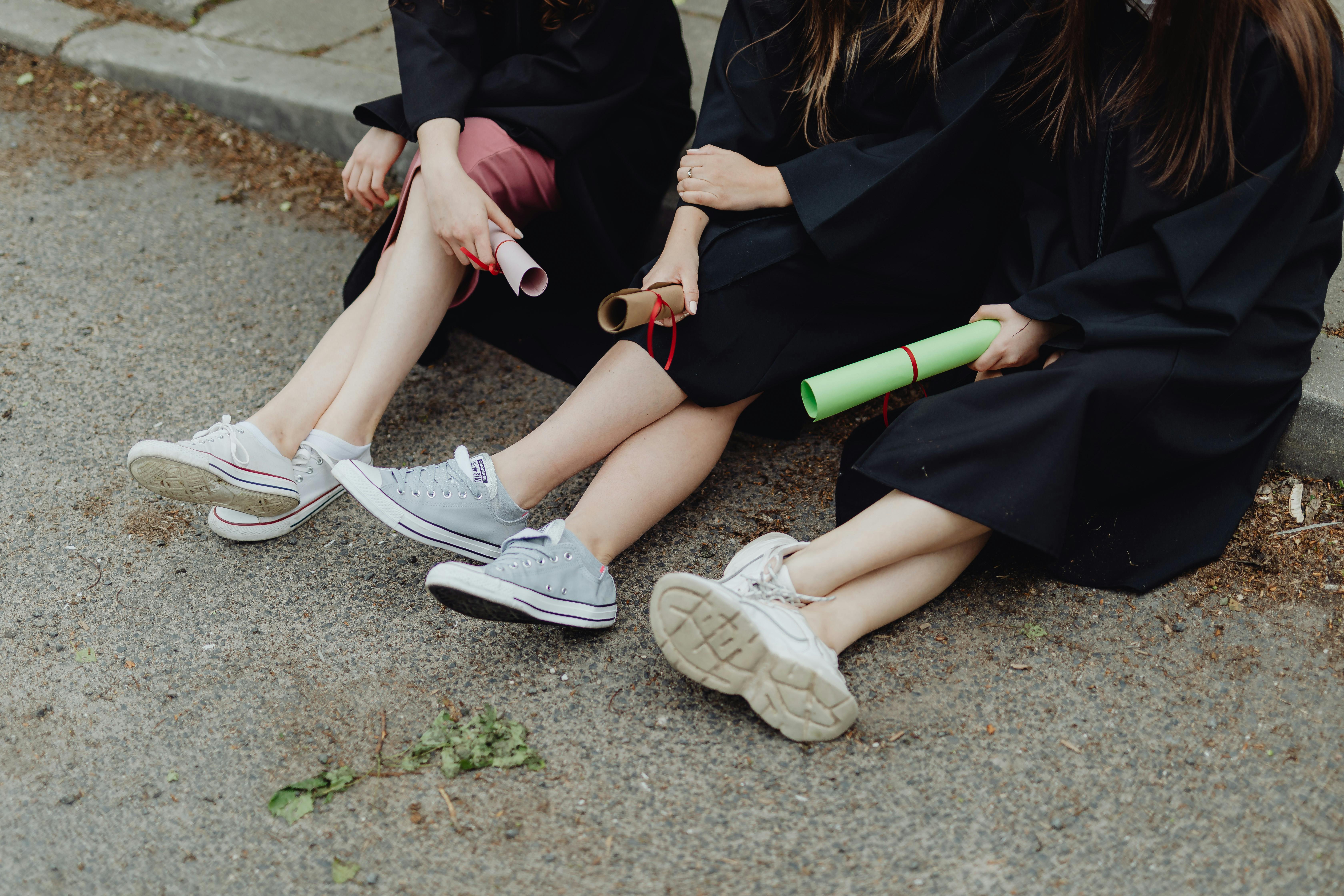 High school grads sitting on curb