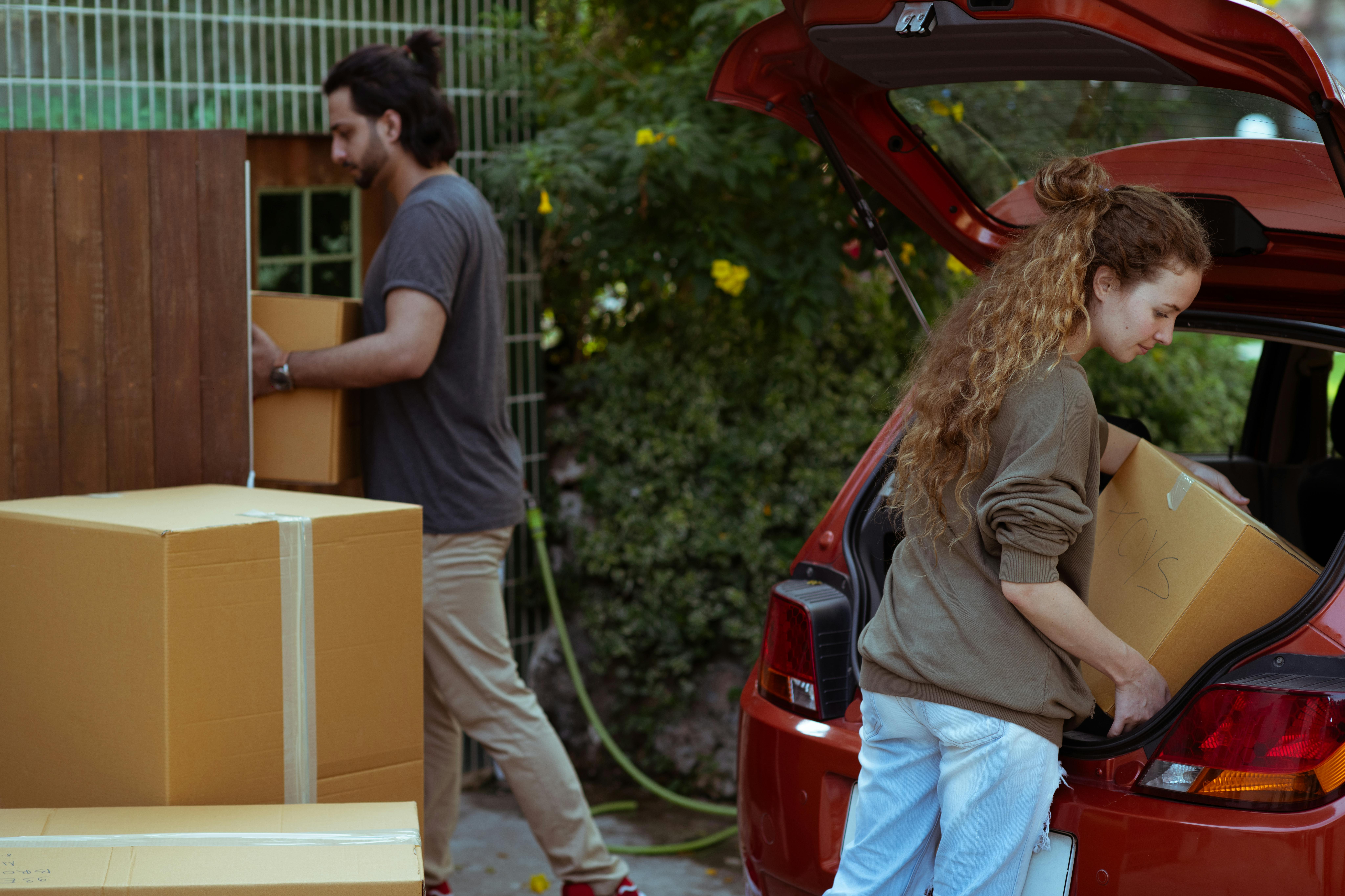 Couple packing car to move house
