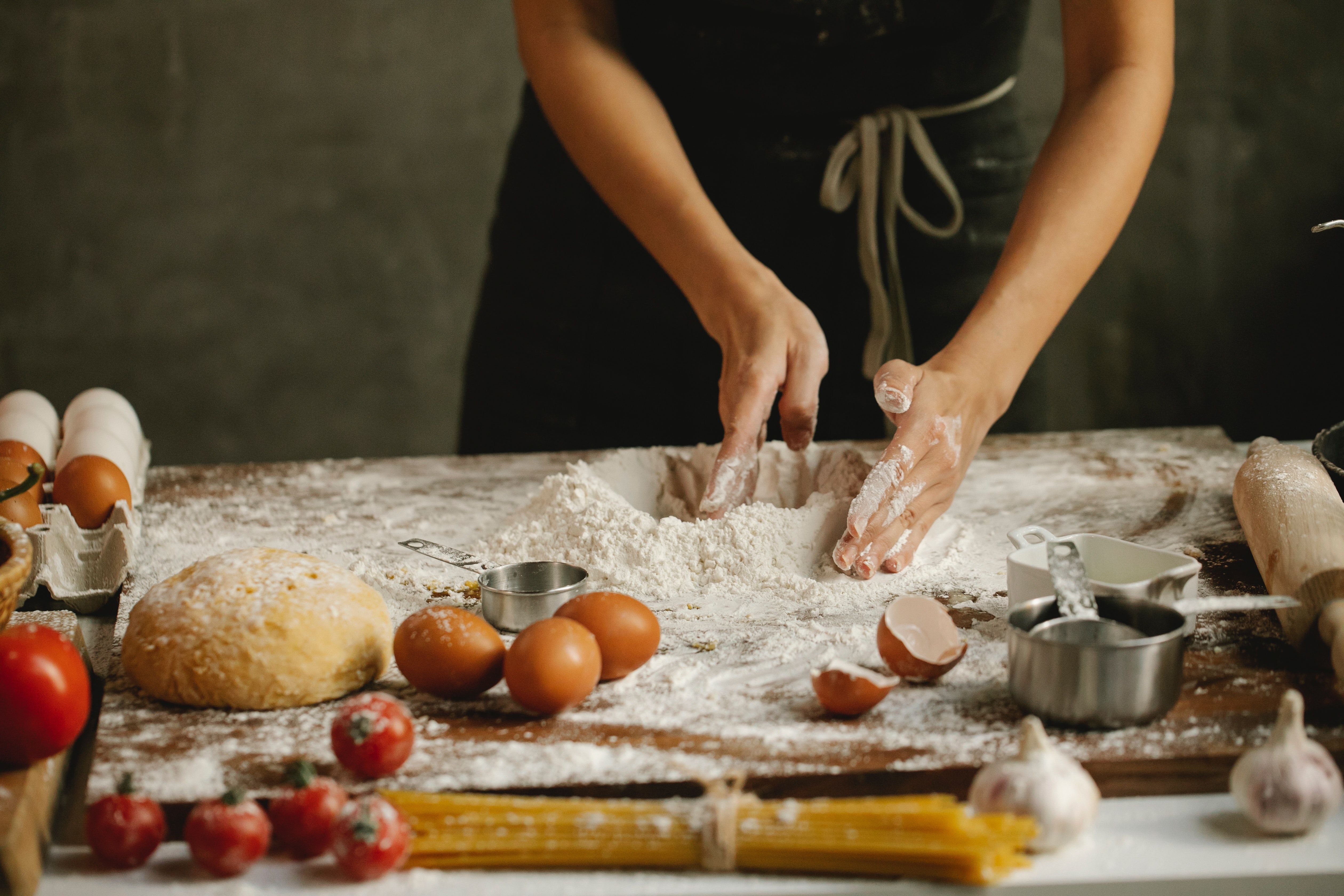 Woman making pasta on table