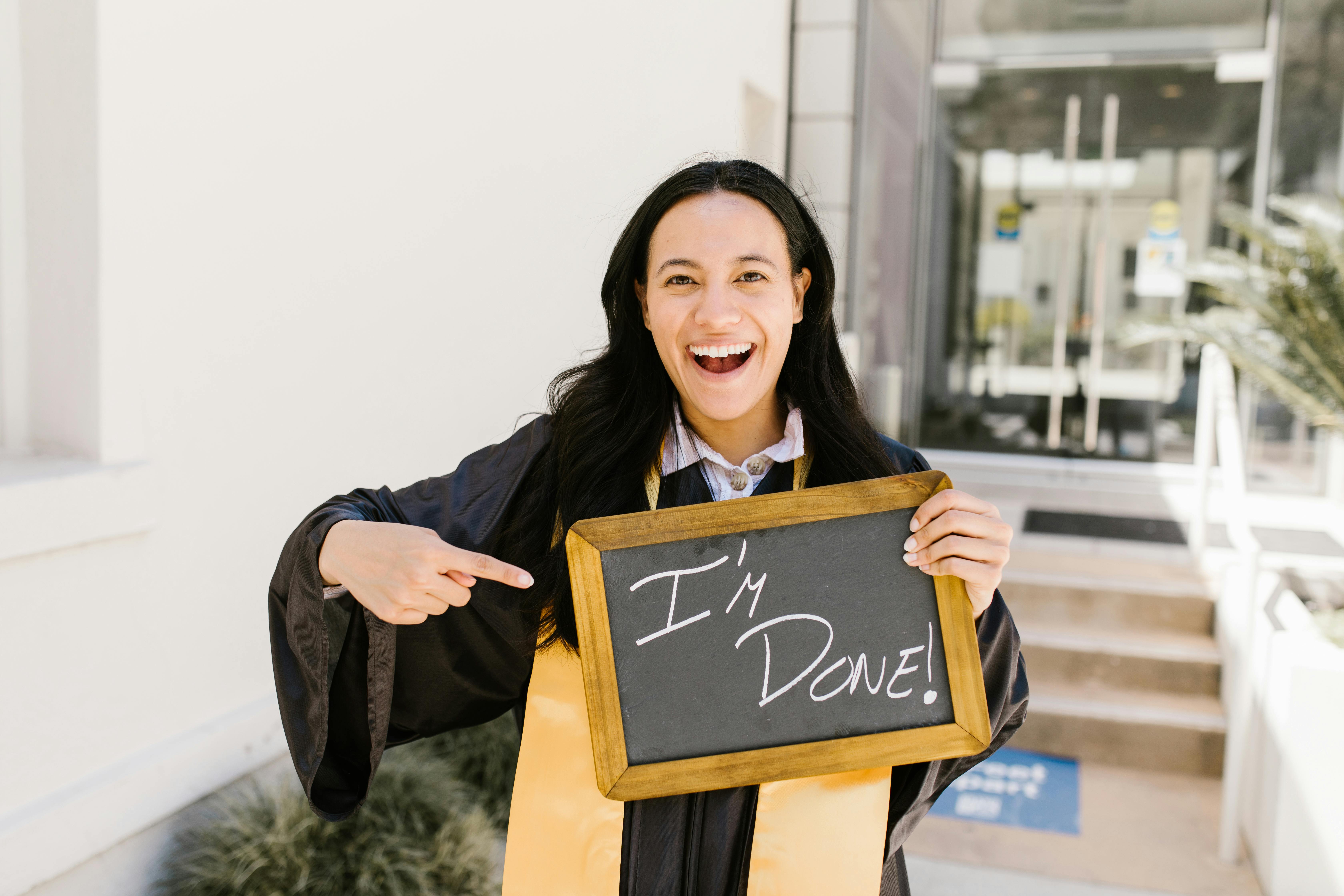 Grad holding sign