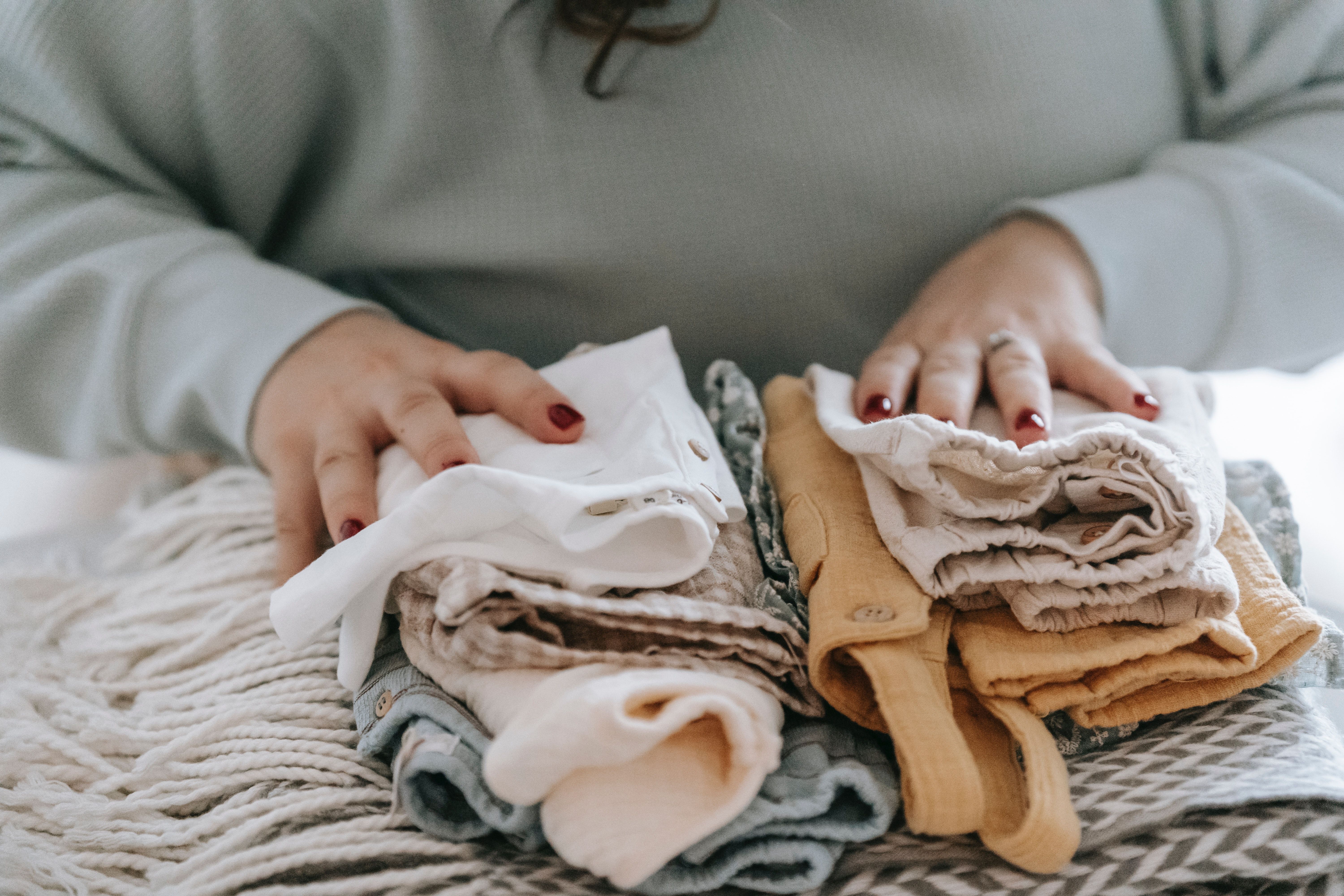 folded pile of baby clothes