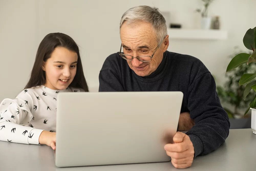 Grandpa and grandaughter looking at digital photos